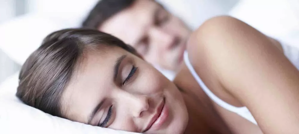 Couple sleeping peacefully in bed